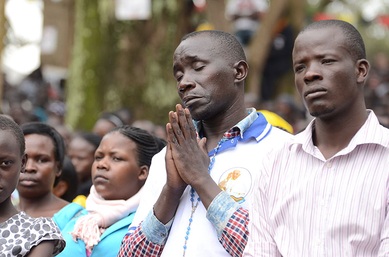 man-praying-at-namugongo