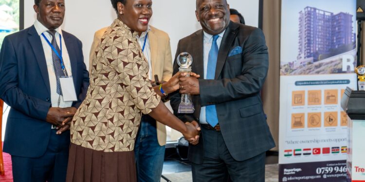 George William Nyombi Thembo, executive director of the Uganda Communications Commission, accepts his 2024/25 Business Trendsetter Public Sector award from Joanita Menya, managing director of Vivo Energy Uganda, at the 6th Business Trendsetters' Forum and Awards Gala on Thursday. Thembo was recognized for his role in driving Uganda's digital progress.