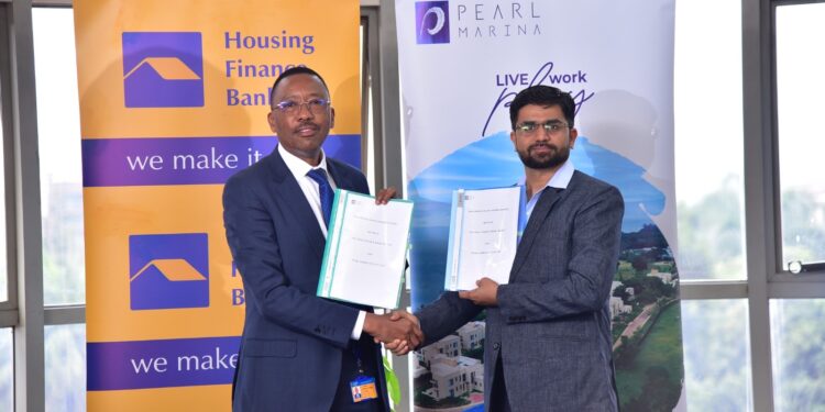 Michael Mugabi, Managing Director of Housing Finance Bank, and  Piyush Dixit the General Manager of Pearl Marina respectively pose for a photo after the signing of the MOU with Pearl Marina Estate