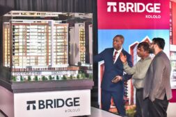 brian-arineitwe-vaal-head-of-sales-showing-clients-the-different-elements-of-the-bridge-253x169-2 The Bridge Kololo — VAAL Uganda’s boldest development yet — is a landmark-in-the-making featuring twin towers linked by a skybridge, 25 luxury lifestyle amenities, and panoramic views of Lake Victoria and Kampala’s skyline. From a heated pool and private cinema to a rooftop café, co-working lounge, and wellness spaces, every detail redefines what it means to live above the city. A rare opportunity in Kololo’s most exclusive neighborhood — crafted for those who value elegance, comfort, and investment-worthy living.