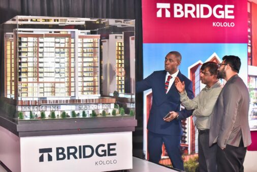 brian-arineitwe-vaal-head-of-sales-showing-clients-the-different-elements-of-the-bridge-506x338-1 The Bridge Kololo — VAAL Uganda’s boldest development yet — is a landmark-in-the-making featuring twin towers linked by a skybridge, 25 luxury lifestyle amenities, and panoramic views of Lake Victoria and Kampala’s skyline. From a heated pool and private cinema to a rooftop café, co-working lounge, and wellness spaces, every detail redefines what it means to live above the city. A rare opportunity in Kololo’s most exclusive neighborhood — crafted for those who value elegance, comfort, and investment-worthy living.
