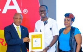 state-minister-for-ict-godfrey-kabbyanga-l-handing-over-the-award-to-centenary-banks-manager-of-sustainability-emmanuel-otuko-at-the-brand-africa-awards-2025-272x169-3