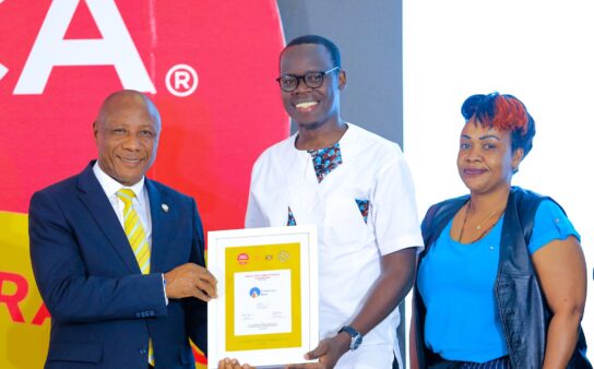 state-minister-for-ict-godfrey-kabbyanga-l-handing-over-the-award-to-centenary-banks-manager-of-sustainability-emmanuel-otuko-at-the-brand-africa-awards-2025-544x338-2
