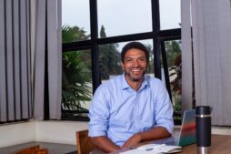 Peter Magona, Managing Director of TBWAUganda, in various settings including team meetings, award celebrations, and office portraits, reflecting his leadership in the advertising industry.