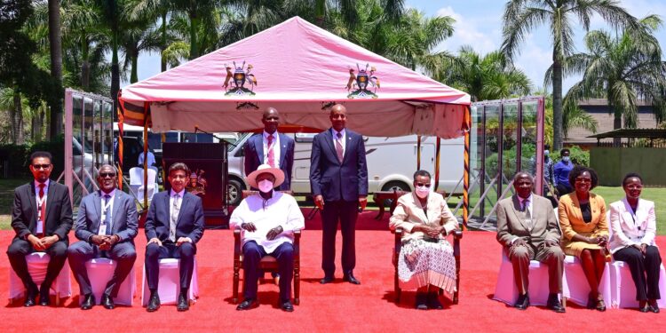 President Museveni (C) and First Lady Janet poses for a photo with some of the delegates attending the Uganda Development Finance Summit at Speke Resort Munyonyo on Monday.
